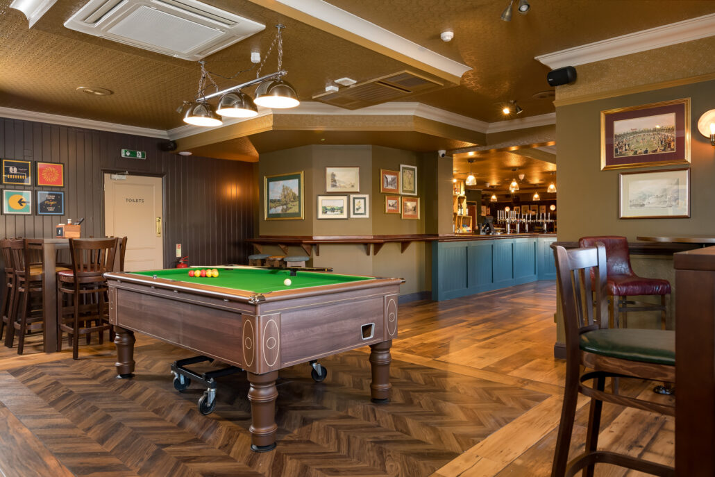 Comfortable bar seating around a brand new pool table in a cosy bar space.